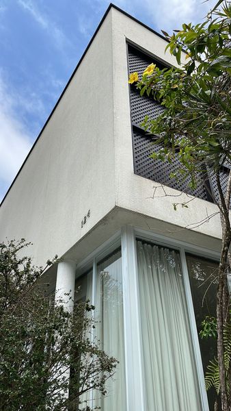Before: This 1956 house in São Paulo, Brazil, was originally designed by the modernist João Batista Vilanova Artigas and when new owners bought it in 2021, it had much of its original detail, such as the exterior tile and the placement of the muxarabi screens.