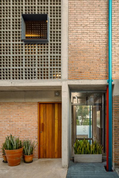 Massive Concrete Screens Bring Plenty of Light and Air to This Sandwiched-In Brazilian Home
