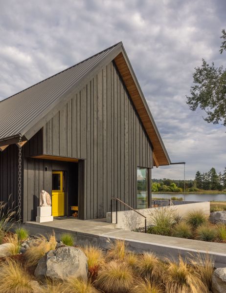 Hale placed a mudroom with a yellow Dutch door facing the brick house, as well as a walkway, with the idea that people would be tramping back and forth between the two places.