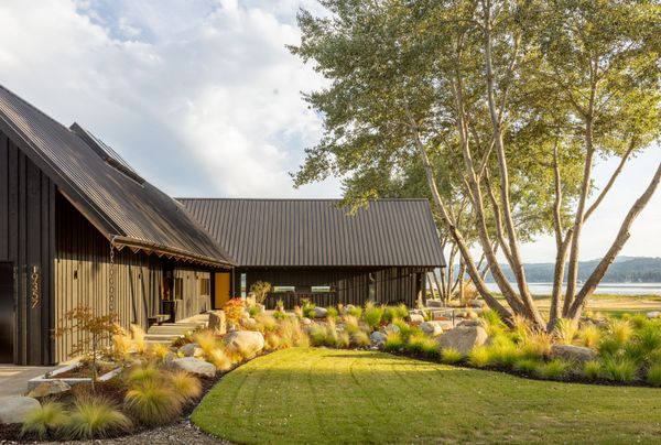 The cedar reverse board-and-batten siding on the home is stained in Benjamin Moore, Arborcoat, Wrought Iron. The siding was loosely inspired by the clinker brick on the other house, which is not "totally uniform,
