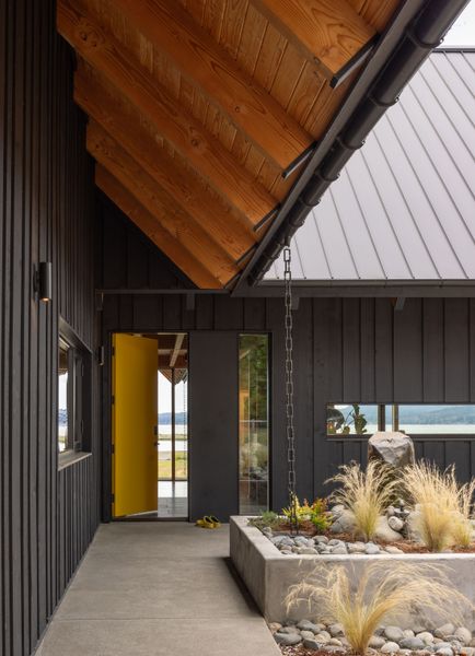 The front door, painted Benjamin Moore, Viking Yellow, opens to views of the water.