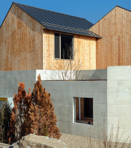 Kissing Gables Perched Atop a Plinth Form a Retired Couple’s Home in South Korea