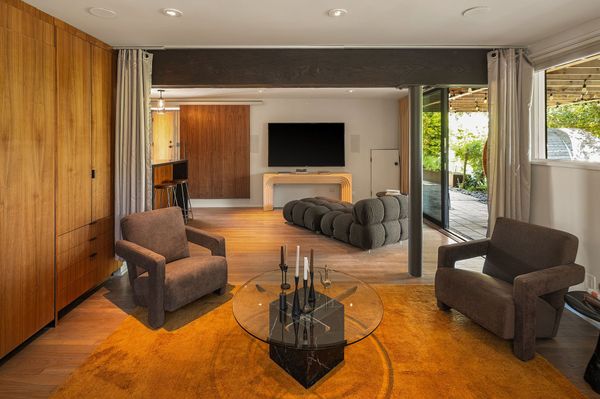A curtian track allows areas of the living room to be sectioned off.