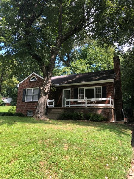 Katie and JT's circa-1950s Cape Cod-style house, about five minutes' drive from the University of Virginia, where they teach, was what Katie called "the standard American starter home,
