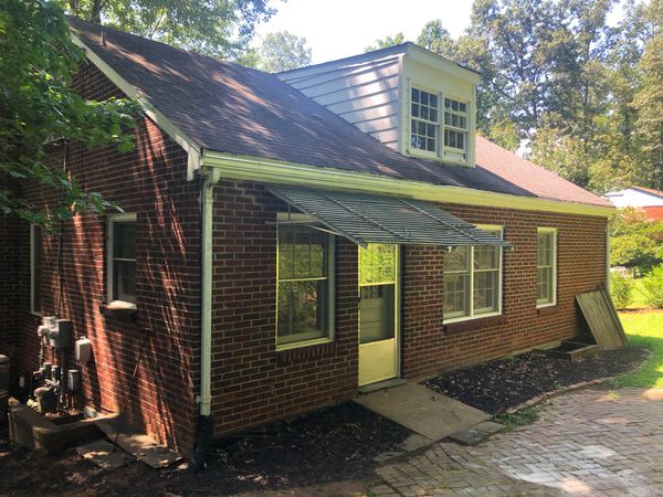 The house's back wall and patio prior to renovation.