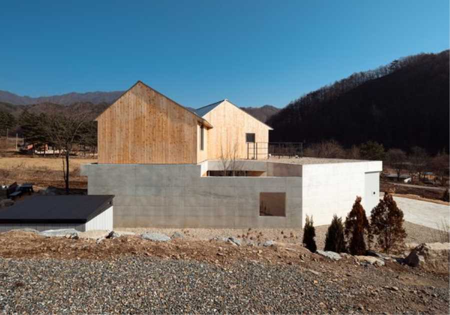 Kissing Gables Perched Atop a Plinth Form a Retired Couple’s Home in South Korea