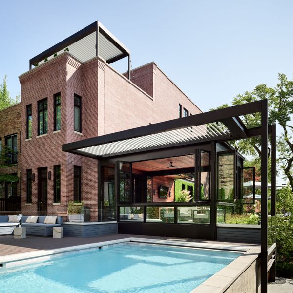 This $7.7M Classic Chicago Home Made of Limestone and Brick Hides a Striking Sunroom