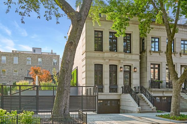 This $7.7M Classic Chicago Home Made of Limestone and Brick Hides a Striking Sunroom