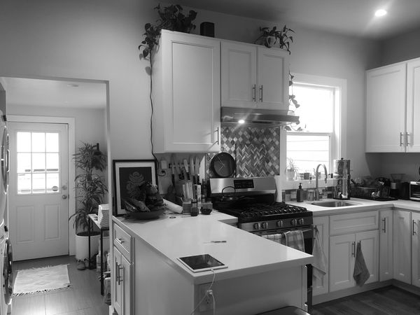 Before: The home had been divided up into two units. The couple wanted to expand the second-floor kitchen and connect it to the rear deck.