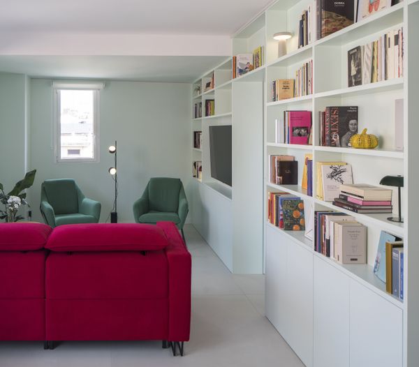 The all-important red sofa is from Temasdos. It's mirrored by two tulip-shaped armchairs from Nacher and a floor lamp from Muuto.