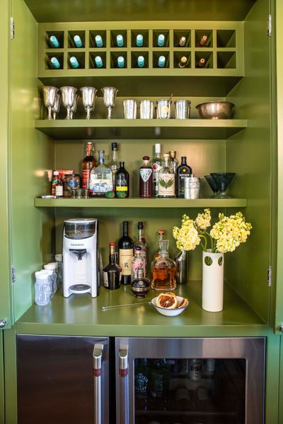 Behind a set of cabinet doors is a full bar, which is on full display for dinner parties.