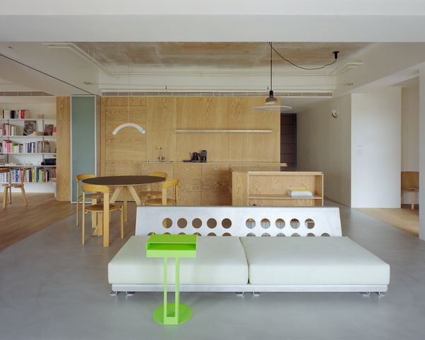 Glass-brick walls enclose the bathrooms and a folding door with frosted panels separates the office.