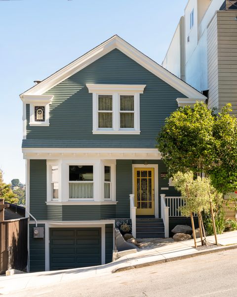 The couple worked with Bach Architecture on a remodel and 1000-square-foot addition to the house, expanding the kitchen, and adding an office, second living room, and sauna to the lower level. The front exterior remained the same throughout, with Benjamin Moore paint in White Heron on the trim, and Caldwell Green on the siding.