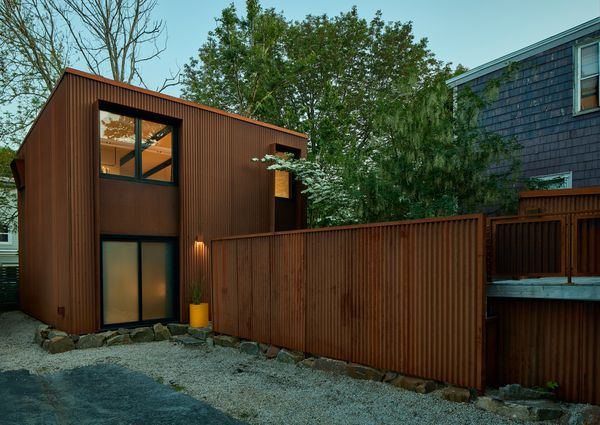 Corrugation and texture elevate what could otherwise be a simple shed form.