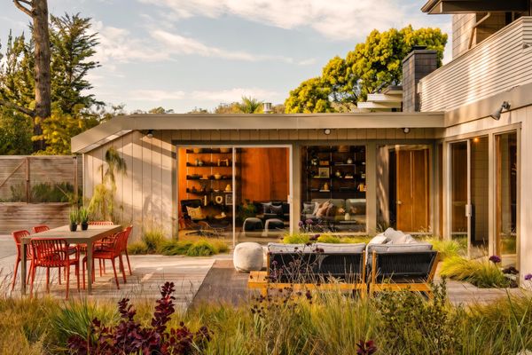 Signature Eichler design elements like including floor-to-ceiling windows large operable glass doors seamlessly connect the home to the exterior.