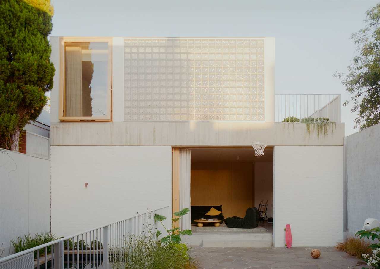 Olaver Architecture ran a two-storey studio across the back of the block and set the pool in the gap between it and the main house. Recycled white brick, a concrete band beam, and a wall of glass block face the garden. Angelucci butterfly chairs sit poolside. "It was really important that it be a beautiful object in the backyard," Olaver says.