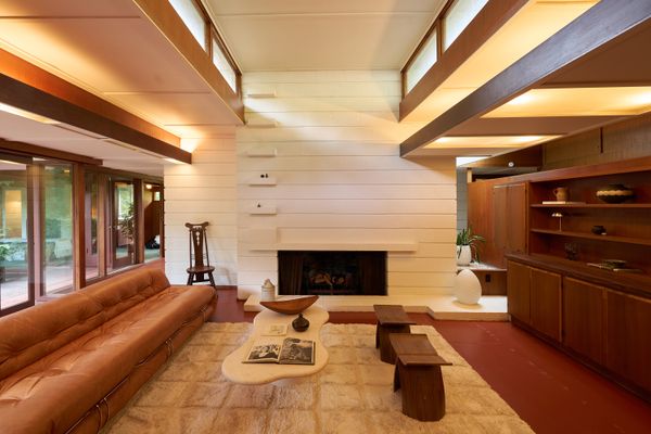A white concrete fireplace anchors the living room.