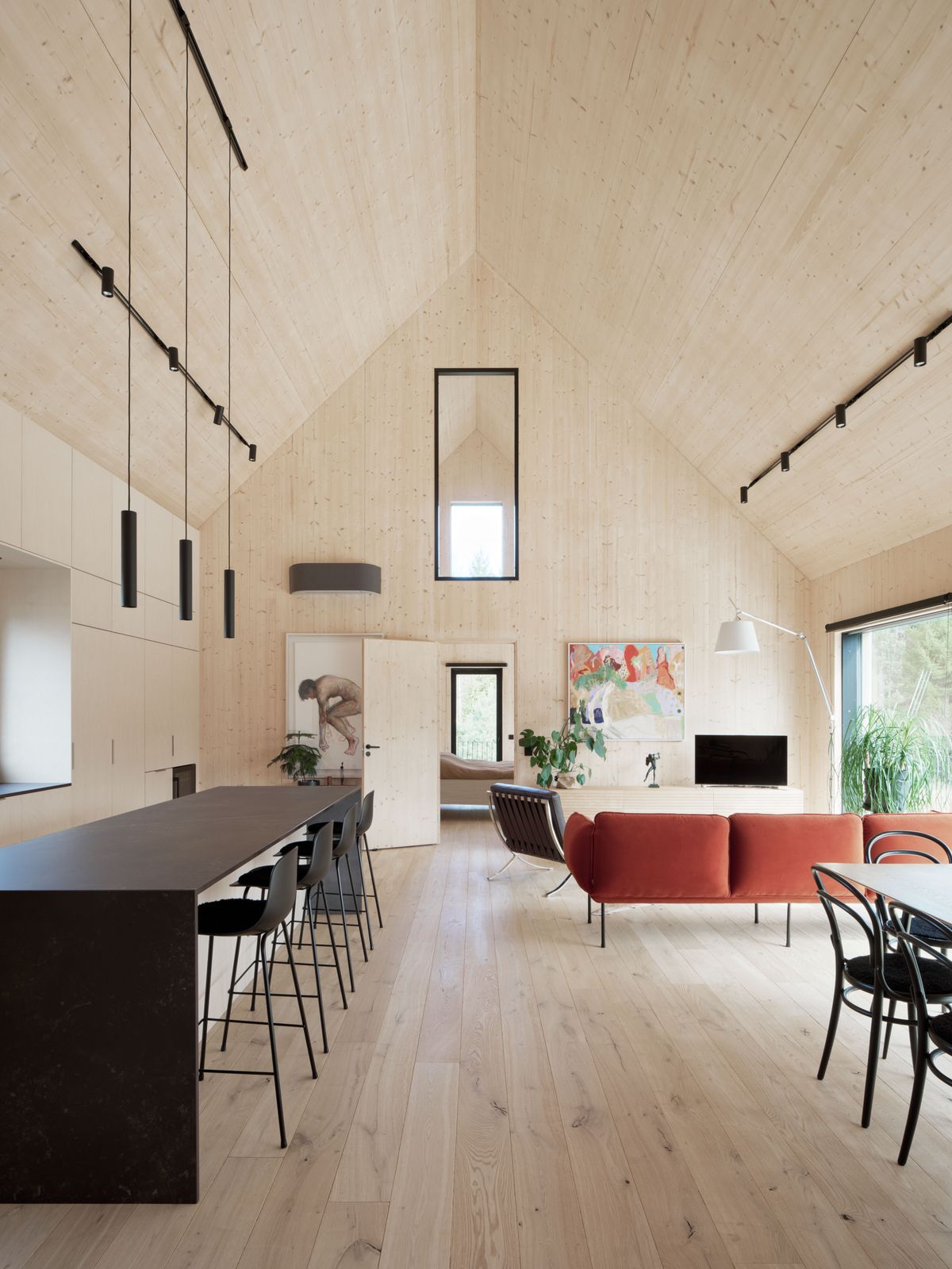 Designed by architect Pekka Airaxin of Kainuu, this home in Finland for couple Nicholas Anderson and Tuire Niemi exposes its structural CLT with 21-foot-tall gabled ceilings.