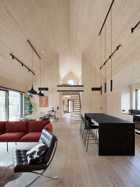 Architect Airaxin designed the home's accent lighting with Finnish company Spigot but the ceiling track lighting is from SuperLED. The living room seating area includes a Nakki sofa by Woud Design and a Barcelona chair by Ludwig Mies van der Rohe.