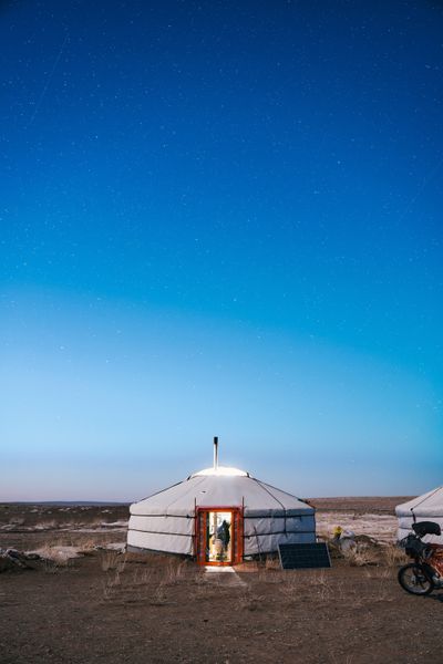 In Mongolia’s Erdenedalai District, herders Nergui Araldiipurev and Tsegmed Davaasamnuu set up camp with more than 800 livestock on a site where they generally live from the end of October until mid-June each year. The couple’s live-in ger, the traditional dwelling used by Mongolian herders, sits near a guest ger and a storage ger and container (pictured in the top photo) where they leave some of their belongings when they move from their winter site to the summer pastures. A solar panel allows them to power a TV (served by a satellite dish) and a freezer.