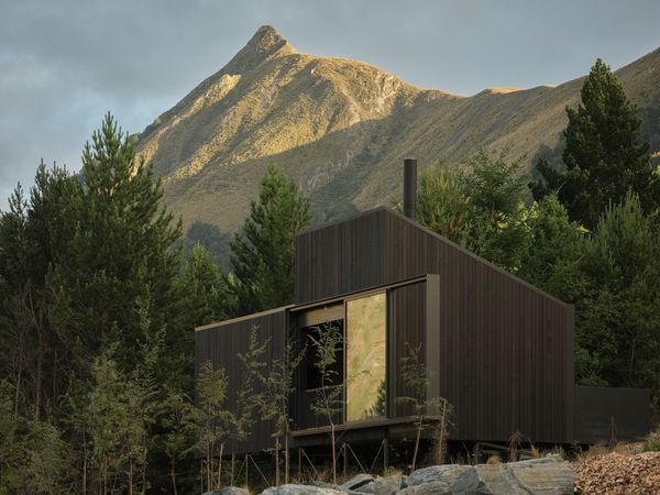 This New Zealand Tiny Cabin’s Glass Sliders Are So Big They Hang Off the Side