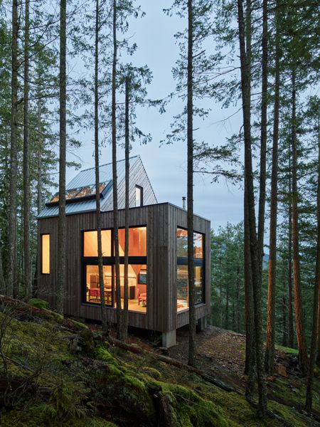 The pre-fab building was fabricated by BC Passive House in Pemberton, British Columbia, and delivered via helicopter to the property in the woods.