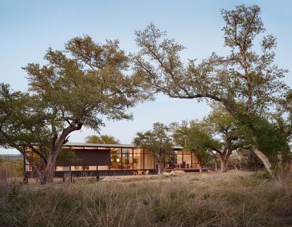 Architect Miguel Rivera sited his Texas Hill Country weekend house on the highest point of a 25-acre plot, strategically avoiding the surrounding oak trees.